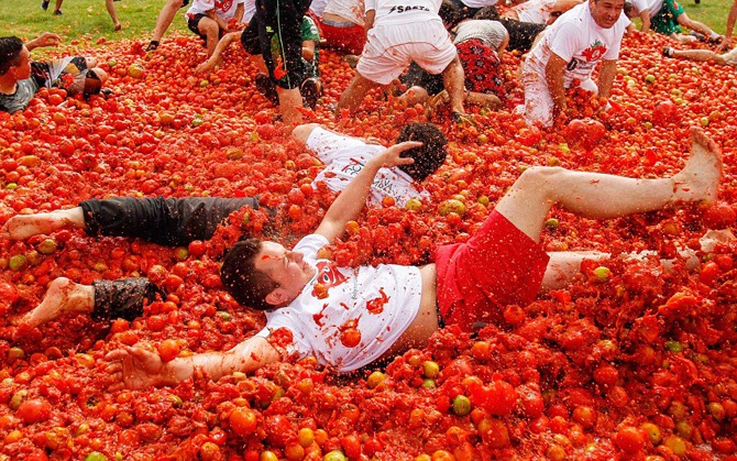Mandatory Credit: Photo by JHON PAZ / Rex Features (2428793b) Revellers take part in the annual tomato fight Tomatina Festival, Bunol, Spain - 03 Jun 2013